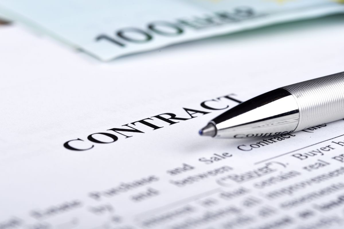 Legal contract signing with money. Buying an selling house or real estate.